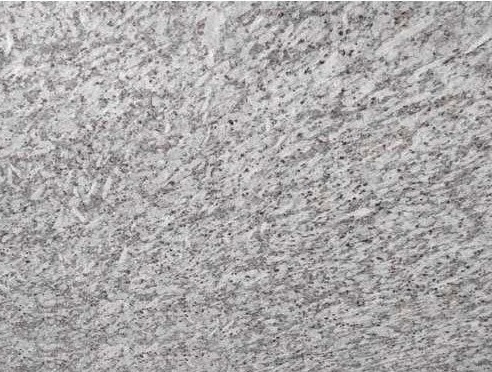 Close-up of light grey granite with fine dark grain