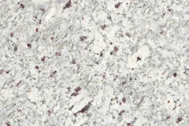 Close-up of white granite with small burgundy speckles