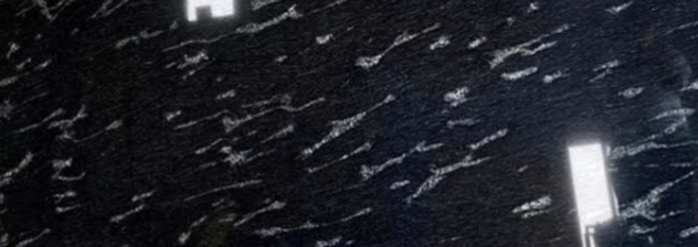 Polished black granite with white wave-like streaks