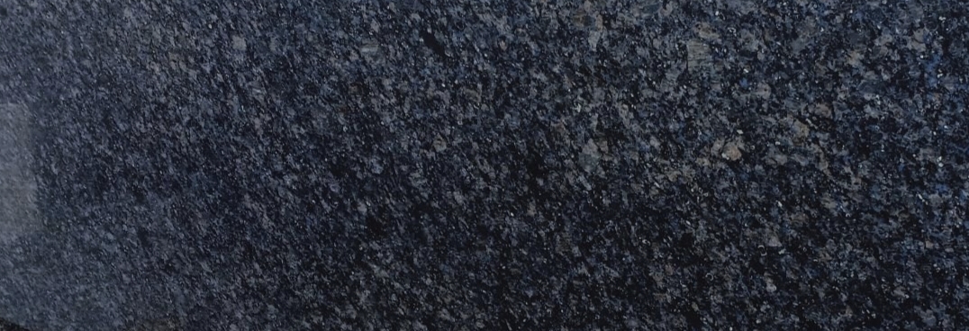 Polished dark granite slab with a fine blue-grey speckle